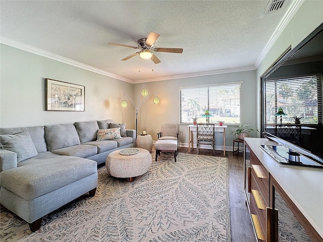 living room with dark hardwood / wood-style flooring, ceiling fan, crown molding, and a textured ceiling