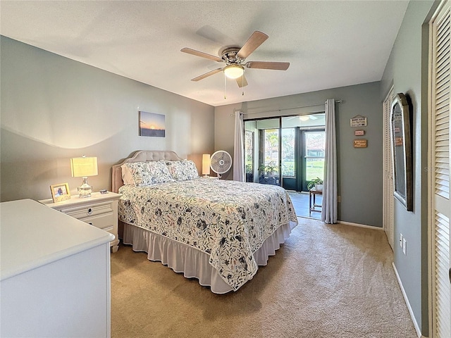 carpeted bedroom with access to exterior, a textured ceiling, and ceiling fan