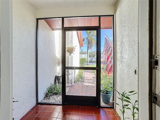 doorway featuring dark tile patterned floors