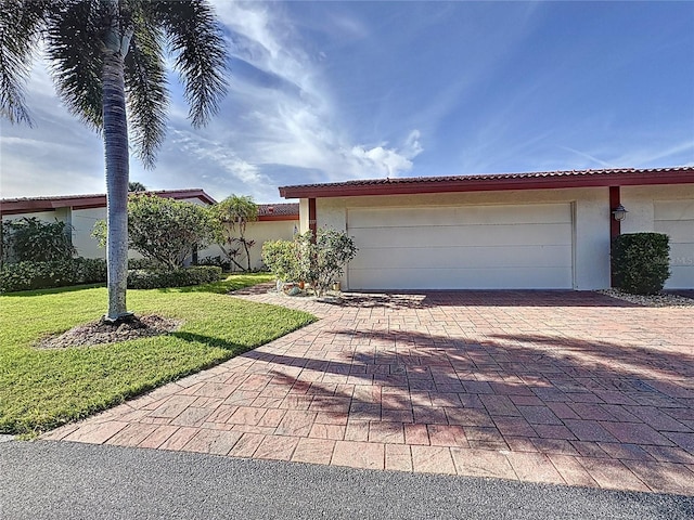 view of front of house with a garage and a front yard