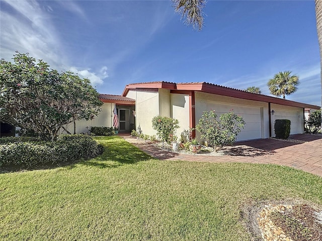 view of front of home with a front yard and a garage