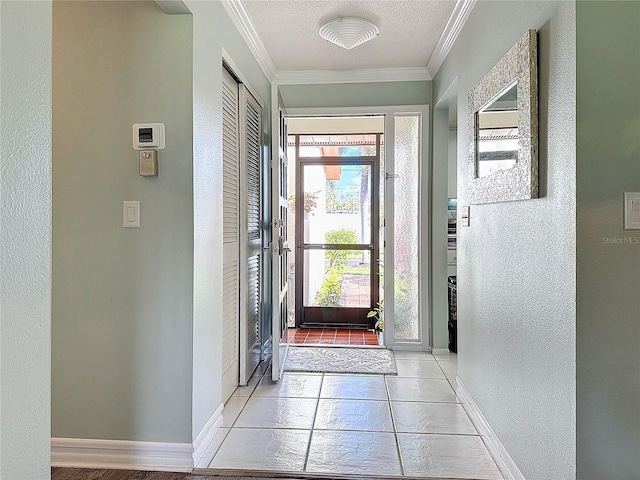 entryway with a healthy amount of sunlight, light tile patterned flooring, ornamental molding, and a textured ceiling