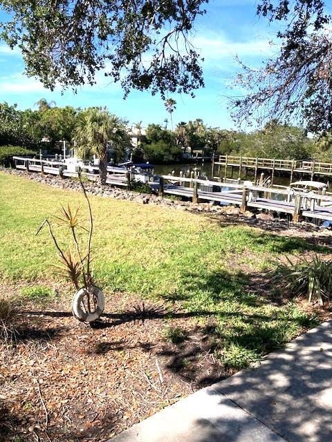 exterior space with a lawn and a dock