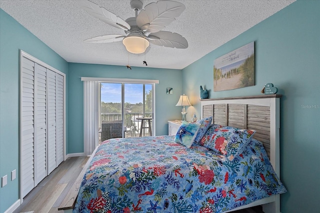 bedroom featuring access to exterior, ceiling fan, a textured ceiling, and light wood-type flooring