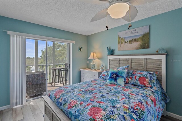 bedroom with access to exterior, hardwood / wood-style floors, a textured ceiling, and ceiling fan