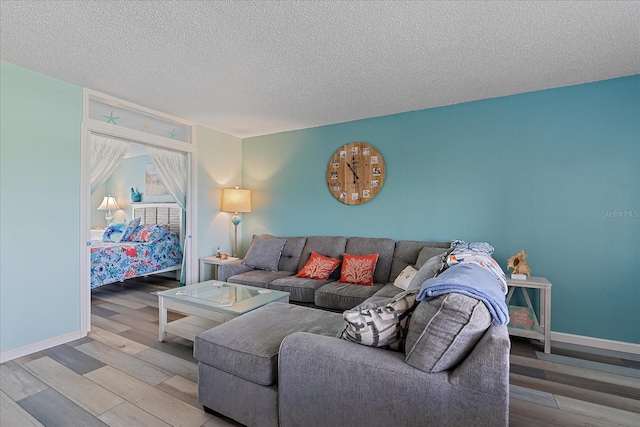 living room featuring a textured ceiling and light hardwood / wood-style floors