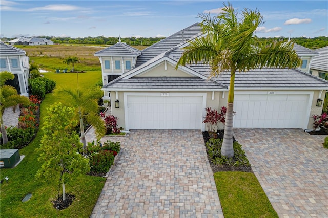 view of front of home featuring a front yard and a garage