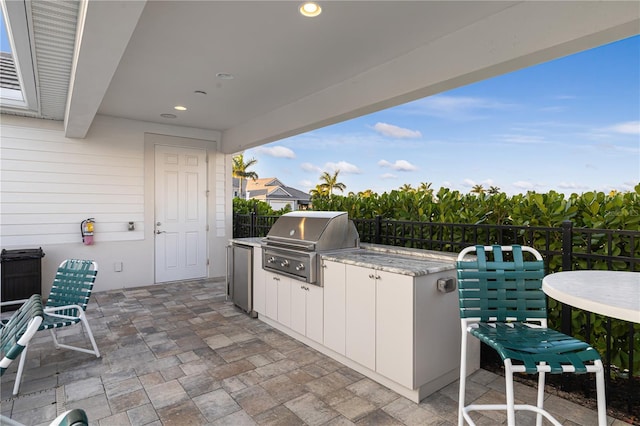 view of patio with an outdoor kitchen and grilling area