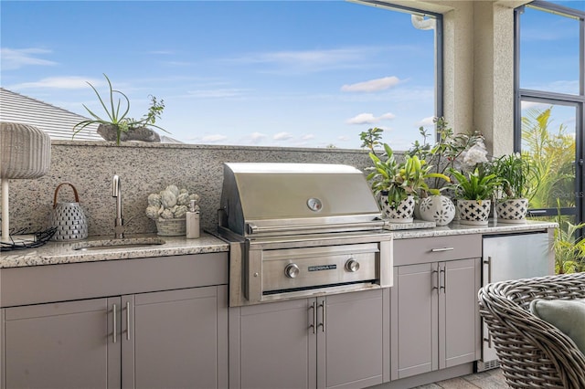 view of patio with grilling area, sink, and an outdoor kitchen