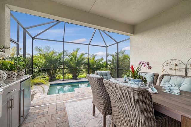 view of swimming pool featuring a lanai and a patio area