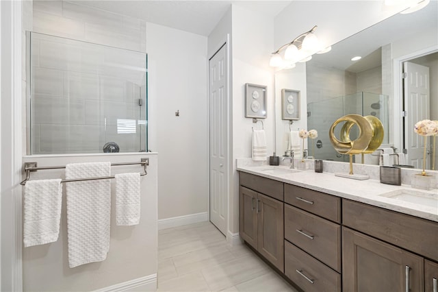 bathroom with tile patterned flooring, vanity, and walk in shower