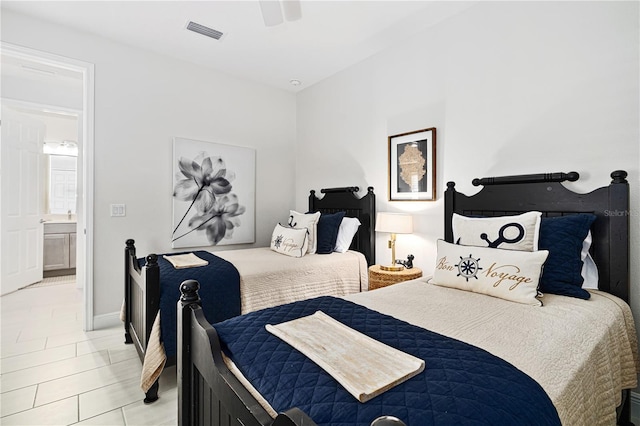 bedroom featuring ensuite bath and ceiling fan