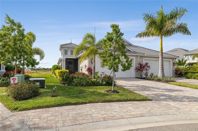 view of front facade with a front yard and a garage