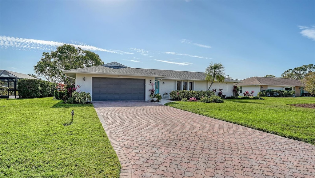 ranch-style house with a garage and a front yard