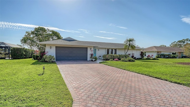 ranch-style house with a garage and a front yard