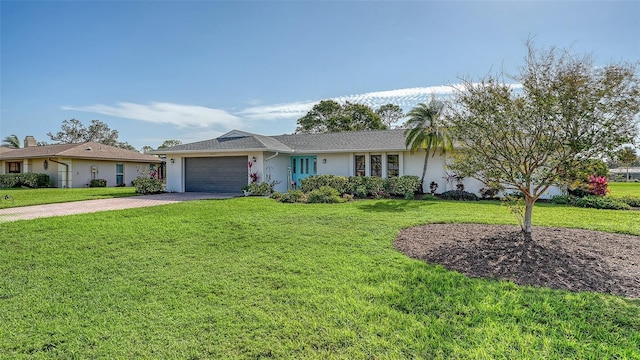 ranch-style house with a garage and a front lawn