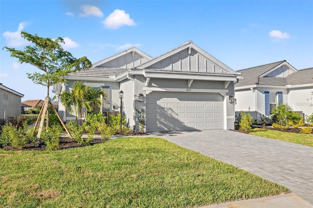 view of front of house with a garage and a front lawn