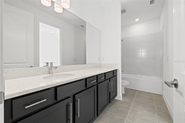 full bathroom featuring washtub / shower combination, tile patterned floors, toilet, and vanity