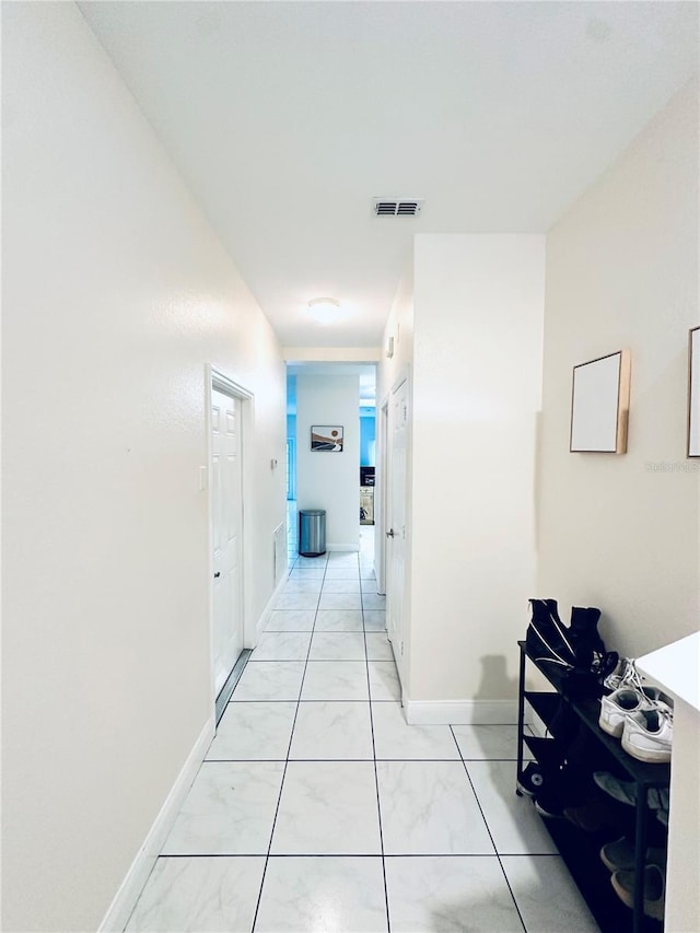 hallway featuring light tile patterned floors