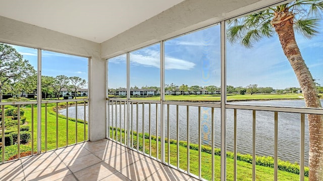 unfurnished sunroom featuring a water view