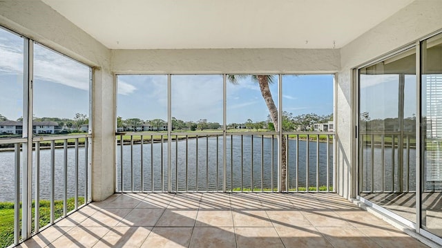 unfurnished sunroom featuring a water view and a wealth of natural light