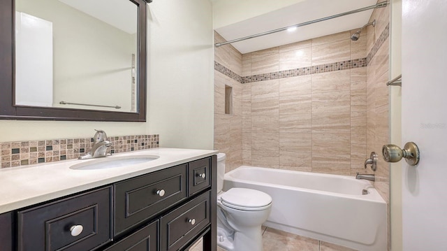 full bathroom featuring tasteful backsplash, tile patterned floors, vanity, toilet, and tiled shower / bath