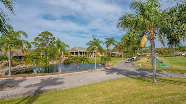 view of community with a water view and a yard