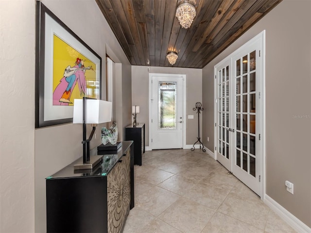 entryway with french doors, light tile patterned floors, and wood ceiling