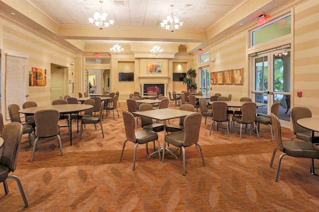 dining space featuring french doors, ornamental molding, and a notable chandelier