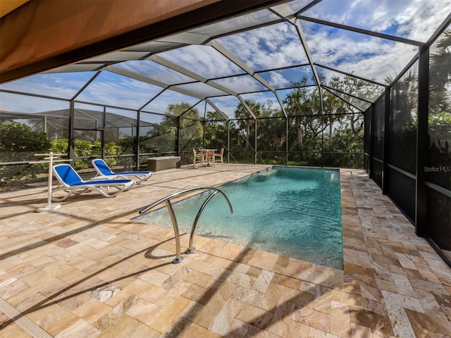 view of swimming pool featuring glass enclosure and a patio area