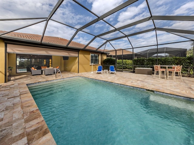 view of swimming pool featuring glass enclosure, a patio area, and an outdoor hangout area