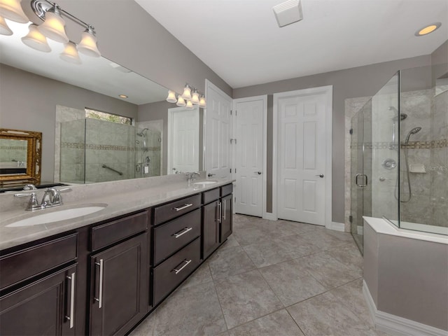 bathroom with tile patterned flooring, vanity, and an enclosed shower