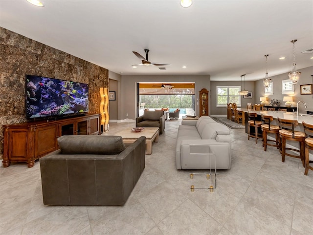 living room with ceiling fan and sink