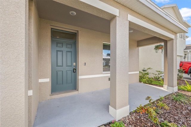 doorway to property featuring covered porch