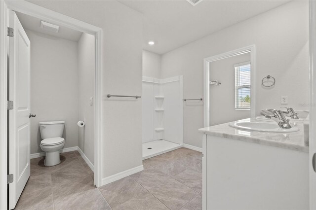 bathroom featuring tile patterned floors, walk in shower, vanity, and toilet