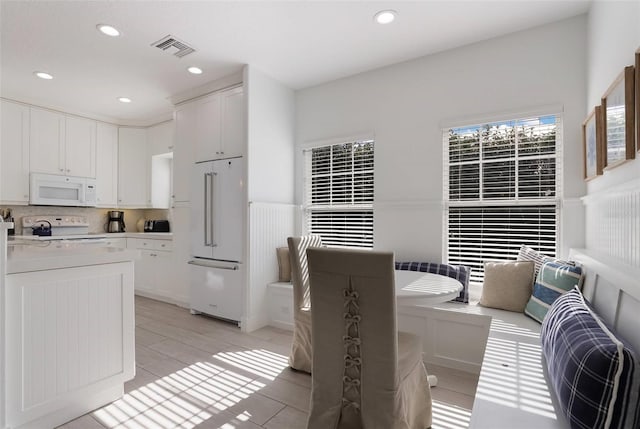 kitchen with white cabinets and white appliances