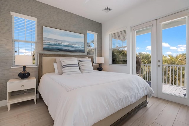 bedroom featuring access to outside and light hardwood / wood-style flooring