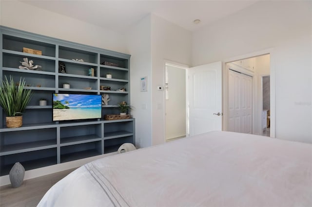 bedroom with hardwood / wood-style floors and a closet