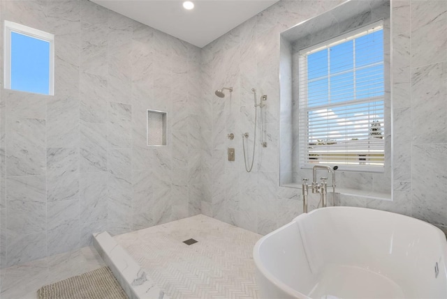 bathroom featuring shower with separate bathtub