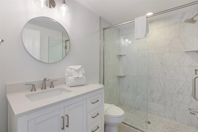 bathroom with vanity, toilet, and a shower with shower door