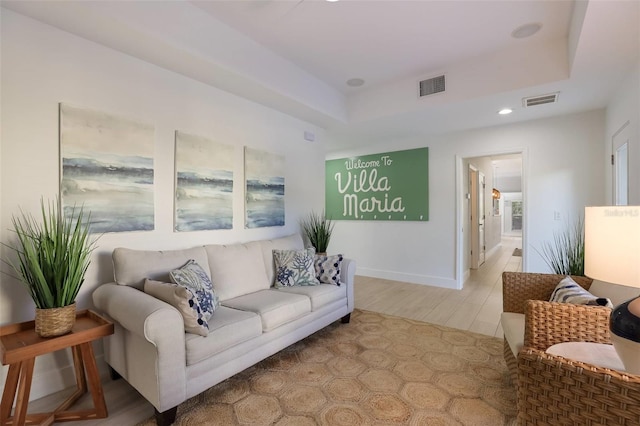 living room with a tray ceiling