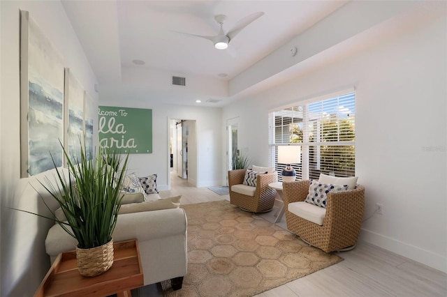 living room with ceiling fan and light hardwood / wood-style floors