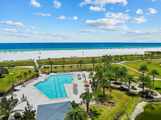 view of pool with a beach view and a water view