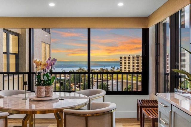 sunroom / solarium with a water view