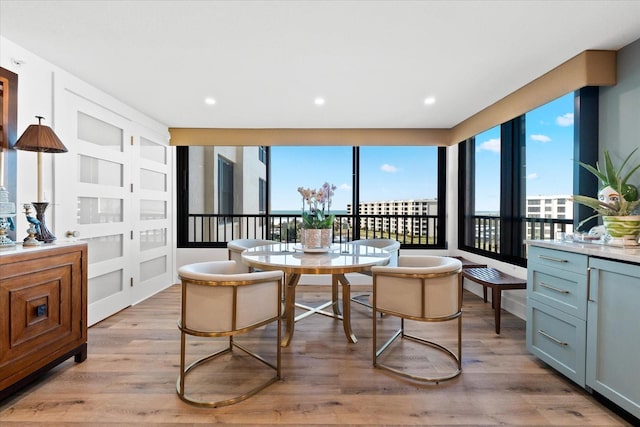 dining space with light wood-type flooring