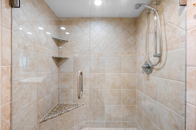 bathroom featuring a shower with door