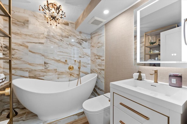 bathroom with a bathtub, vanity, tile walls, and an inviting chandelier