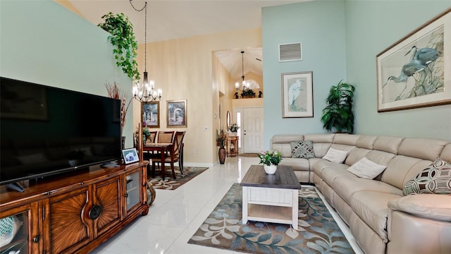 living room with tile patterned floors, a towering ceiling, and a chandelier