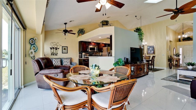 tiled dining area with a notable chandelier and vaulted ceiling