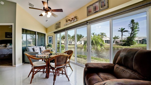 sunroom / solarium featuring ceiling fan, a water view, and vaulted ceiling